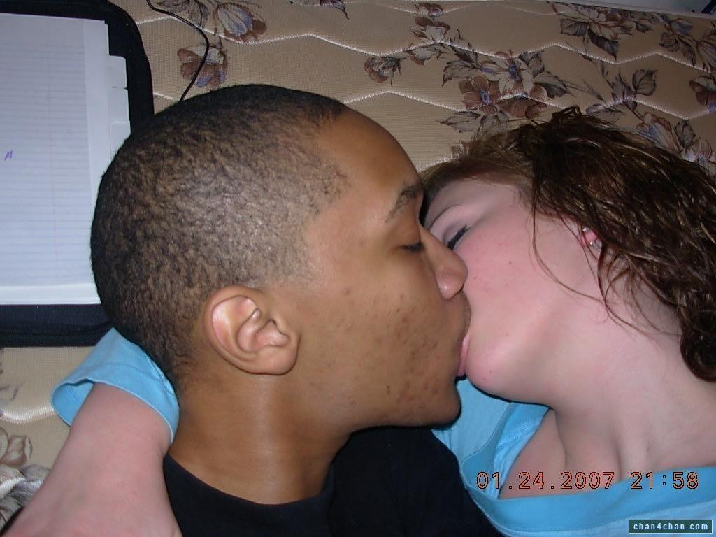Black and white man kissing woman