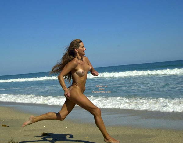 Naked women running on beach