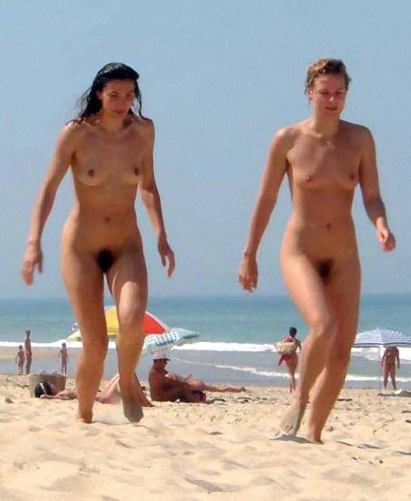 Naked women running on beach