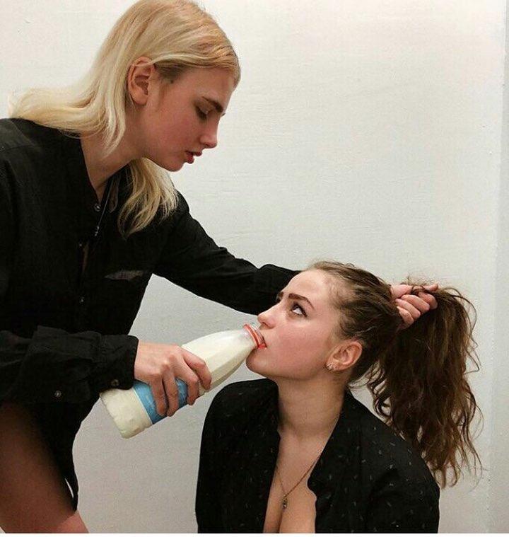 Two girls milking